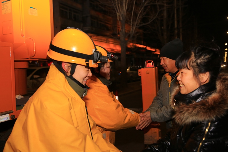 1月1日晚7时，孙绍郁、王思琪在处理故障后和群众握手（常琳）.JPG